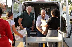 Students loading books into vehicles